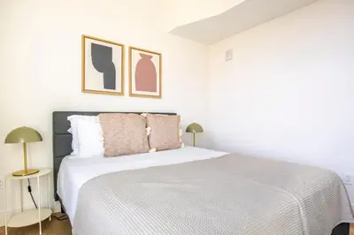 a bedroom with a white bed with two lamps at Blueground East Hollywood rooftop nr Griffith Park LAX-1337 in Los Angeles