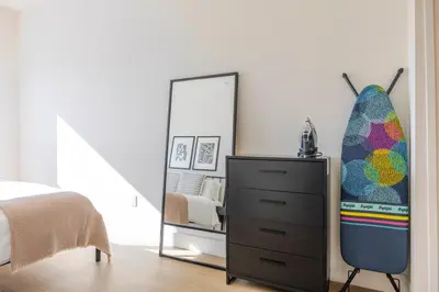 a bedroom with a dresser and a mirror at Blueground East Hollywood rooftop nr Griffith Park LAX-1337 in Los Angeles