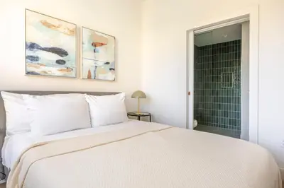 a bedroom with a white bed and a shower at Blueground East Hollywood rooftop nr Hollywood Bowl LAX-1334 in Los Angeles