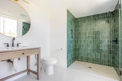 a bathroom with a shower and a toilet and a mirror at Blueground East Hollywood rooftop nr Hollywood Bowl LAX-1334 in Los Angeles