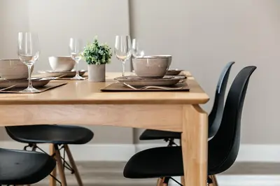 a wooden table with chairs and wine glasses at Excellent Town Home 2BR in WEHO Parking,Gym,Pool in Los Angeles