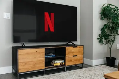 a television on top of a wooden entertainment center at Excellent Town Home 2BR in WEHO Parking,Gym,Pool in Los Angeles