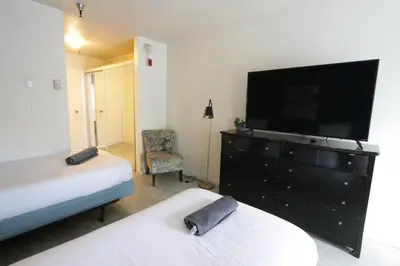 a bedroom with a dresser with a flat screen tv at 3 beds Apart in Beverly Hills in Los Angeles