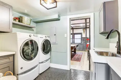 a kitchen with a washer and dryer next to a sink at Walk to Lake Arrowhead Village! Home with Lake Views in Lake Arrowhead