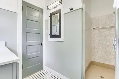 a bathroom with a shower and a glass door at Steps to Lake Arrowhead Village Chic Apartment in Lake Arrowhead