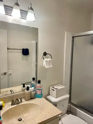 a bathroom with a sink and a toilet and a mirror at Modern West LA Studio with Pool, Gym & Parking in Los Angeles