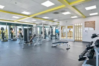a gym with several treadmills and exercise bikes at Modern West LA Studio with Pool, Gym & Parking in Los Angeles