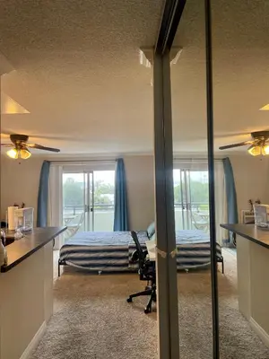 a bedroom with a bed and a desk with a chair at Modern West LA Studio with Pool, Gym & Parking in Los Angeles