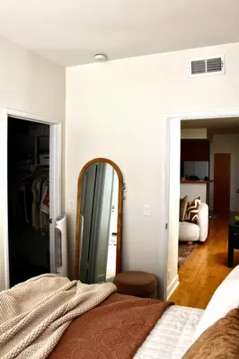 a bedroom with a mirror and a bed at Designer Light-Filled WeHo Condo in Los Angeles