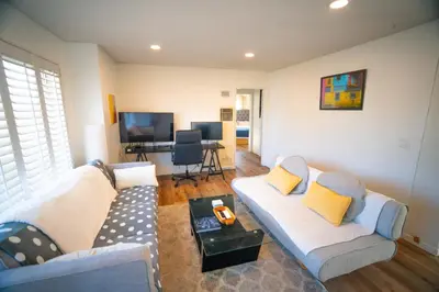 a living room with two couches and a table at Bright and Comfortable 2 Bedrooms with Views in Santa Monica in Los Angeles