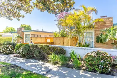 a house with a fence and plants in front of it at Bright and Comfortable 2 Bedrooms with Views in Santa Monica in Los Angeles