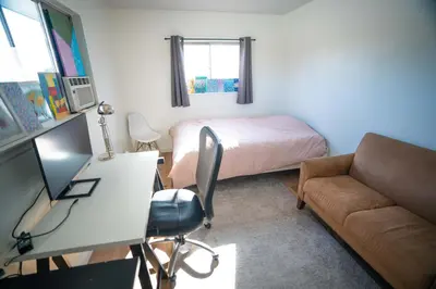 a bedroom with a bed and a desk and a couch at Bright and Comfortable 2 Bedrooms with Views in Santa Monica in Los Angeles