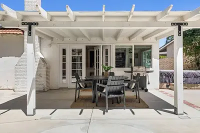 a white pergola with a table and chairs on a patio at Cozy & Bright Santa Clarita Retreat in Santa Clarita