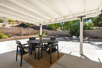 a patio with a table and chairs under a pergola at Cozy & Bright Santa Clarita Retreat in Santa Clarita