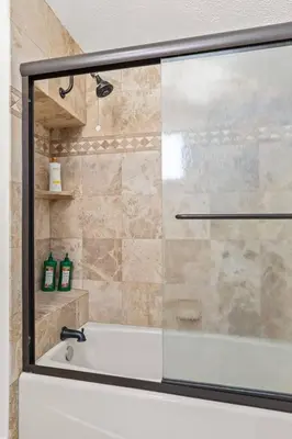 a shower with a glass door in a bathroom at Goode HOMES Stunning Home w/ Beautiful Backyard in Santa Clarita