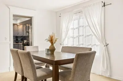 a dining room table with chairs and a vase on it at Goode HOMES Stunning Home w/ Beautiful Backyard in Santa Clarita