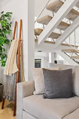 a living room with a couch and a staircase at GOODE.HOMES | Luxury Home w/ Beautiful Garden in Santa Clarita