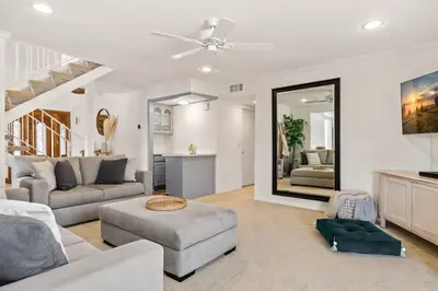 a living room with a couch and a large mirror at GOODE.HOMES | Luxury Home w/ Beautiful Garden in Santa Clarita