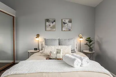 a bedroom with a large bed with towels on it at Luxury Modern Home w/ Jacuzzi | GOODE HOMES in Santa Clarita