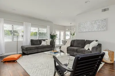 a living room with a couch and a table at Luxury Modern Home w/ Jacuzzi | GOODE HOMES in Santa Clarita