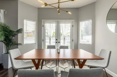 a dining room with a wooden table and chairs at Luxury Modern Home w/ Jacuzzi | GOODE HOMES in Santa Clarita