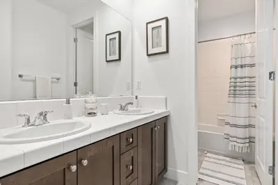 a bathroom with two sinks and a large mirror at Luxury Mountain View Home w/ large backyard in Santa Clarita