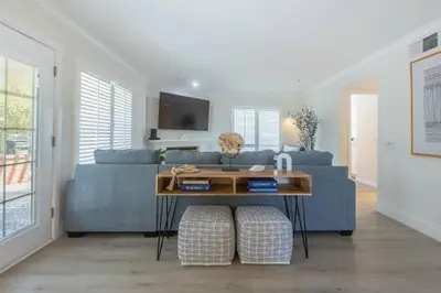 a living room with a blue couch and a table at Goode.Homes Hilltop Home w. private pool/spa in Newhall