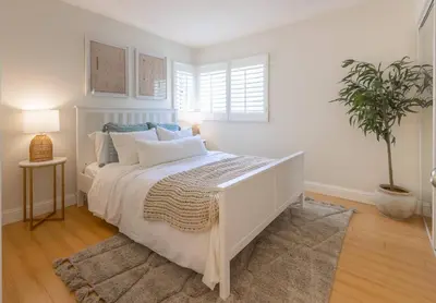 a bedroom with a white bed with a potted plant at Goode.Homes Hilltop Home w. private pool/spa in Newhall