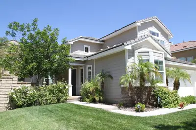 a house with a green lawn at GOODE.HOMES | Luxury Home w/ pool & lush gardens in Santa Clarita