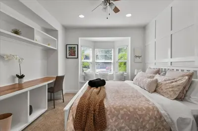 a bedroom with a bed and a desk and a window at GOODE.HOMES | Luxury Home w/ pool & lush gardens in Santa Clarita