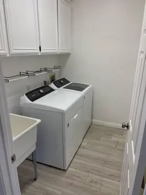 a white kitchen with a stove and a sink at Large 6-bedroom house w/jacuzzi in Monterey Park