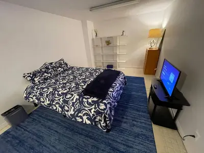 a bedroom with a bed and a flat screen tv at Large 6-bedroom house w/jacuzzi in Monterey Park