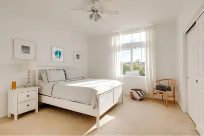 a white bedroom with a bed and a window at Mountain View Home with Pool & Fenced-In Yard in Santa Clarita