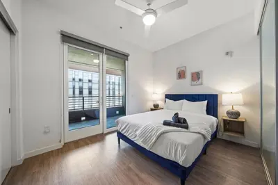 a bedroom with a large bed and a window at Modern Getaway Heart of Long Beach in Long Beach