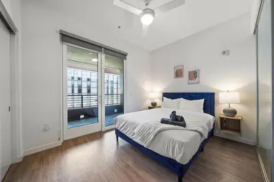 a bedroom with a large bed and a window at Modern Getaway Heart of Long Beach in Long Beach