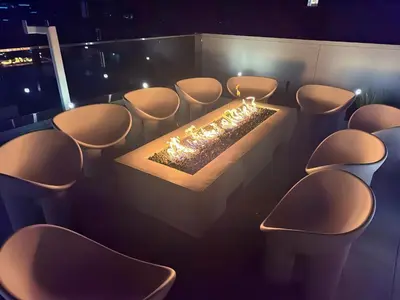 a row of chairs with a fire in a room at Luxury 2BD 2BA with Roof Top Pool, Hot Tub & Gym in Los Angeles