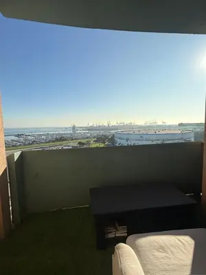 a bedroom with a window with a view of the ocean at Aqua Towers in Long Beach
