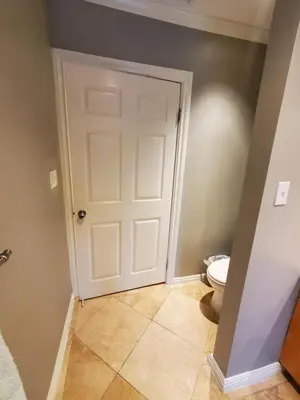 a bathroom with a white door and a toilet at Hidden Gem In Plain Sight in Van Nuys Airport
