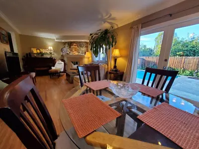a dining room with a table and chairs and a living room at Hidden Gem In Plain Sight in Van Nuys Airport