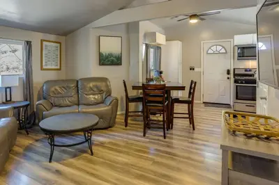 a living room with a couch and a table at Cozy Forest Cottage w Lake Glimpse and Grill in Fawnskin