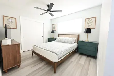 a bedroom with a bed and a ceiling fan at Family Friendly Southwest Bakersfield Retreat with Jacuzzi and Fenced Yard in Bakersfield