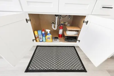 a kitchen pantry with a door open with a mat underneath it at Family Friendly Southwest Bakersfield Retreat with Jacuzzi and Fenced Yard in Bakersfield