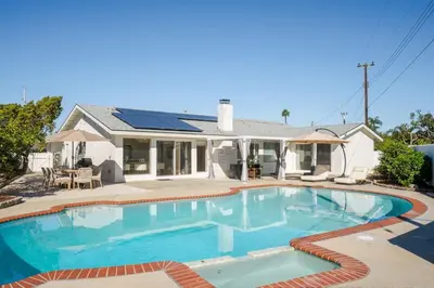 a swimming pool in front of a house at Dream Dip - Heater Pool and Spa - Clost to Disney in Placentia