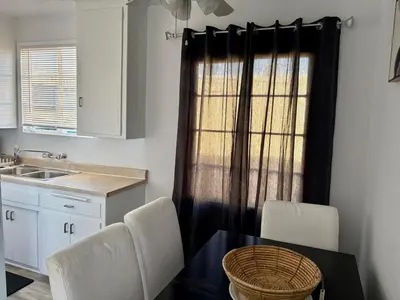 a kitchen with a table and chairs and a window at Unique apartment in Los Angeles