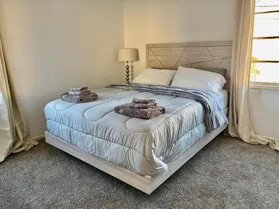a bedroom with a bed with two towels on it at Unique apartment in Los Angeles