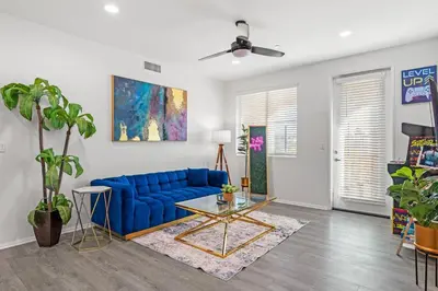 a living room with a blue couch and a table at Cozy 3 BR Apartment | Near Disney in Placentia
