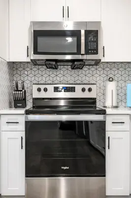 a kitchen with a stainless steel oven with a microwave at Cozy 3 BR Apartment | Near Disney in Placentia