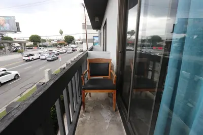 a chair sitting on the balcony of a building at Private Apt with Queen bed in great neighborhood in Los Angeles