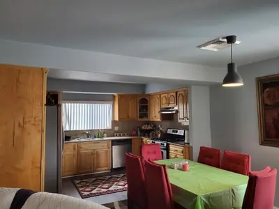 a kitchen with a green table and red chairs at Spacious home near LAX in Hawthorne