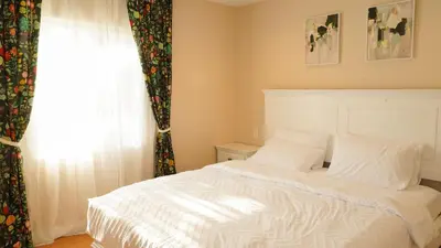 a bedroom with a white bed and a window at Entire house with 3 rooms in Alhambra
